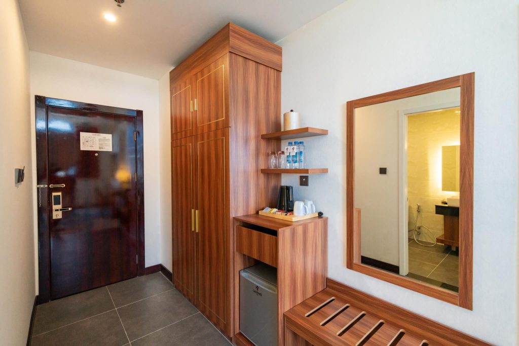 Hotel room amenities: classic wooden wardrobe and dressing mirror in Royal Legend Room, Legend Hotel Sihanoukville.