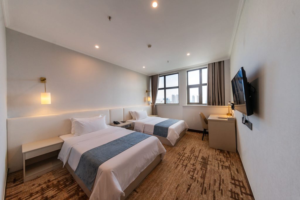 Cozy and spacious Deluxe Twin hotel room with king bed and city view of Sihanoukville, Cambodia.