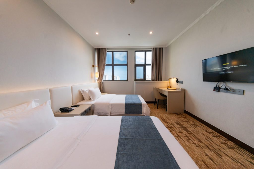 Cozy and spacious Deluxe Twin hotel room with king bed and city view of Sihanoukville, Cambodia.