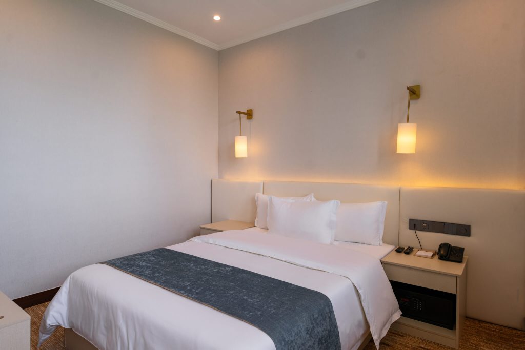 Cozy and spacious Deluxe Queen hotel room with king bed.