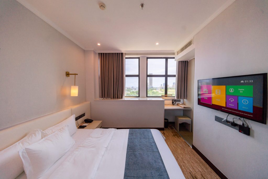 Cozy and spacious Deluxe Queen hotel room with king bed and city view of Sihanoukville, Cambodia.