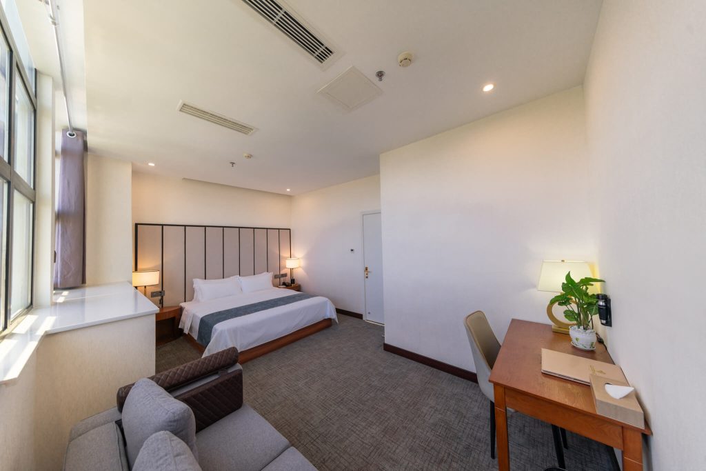 Modern, cozy and spacious Suites hotel room with king bed, ocean view and city view.