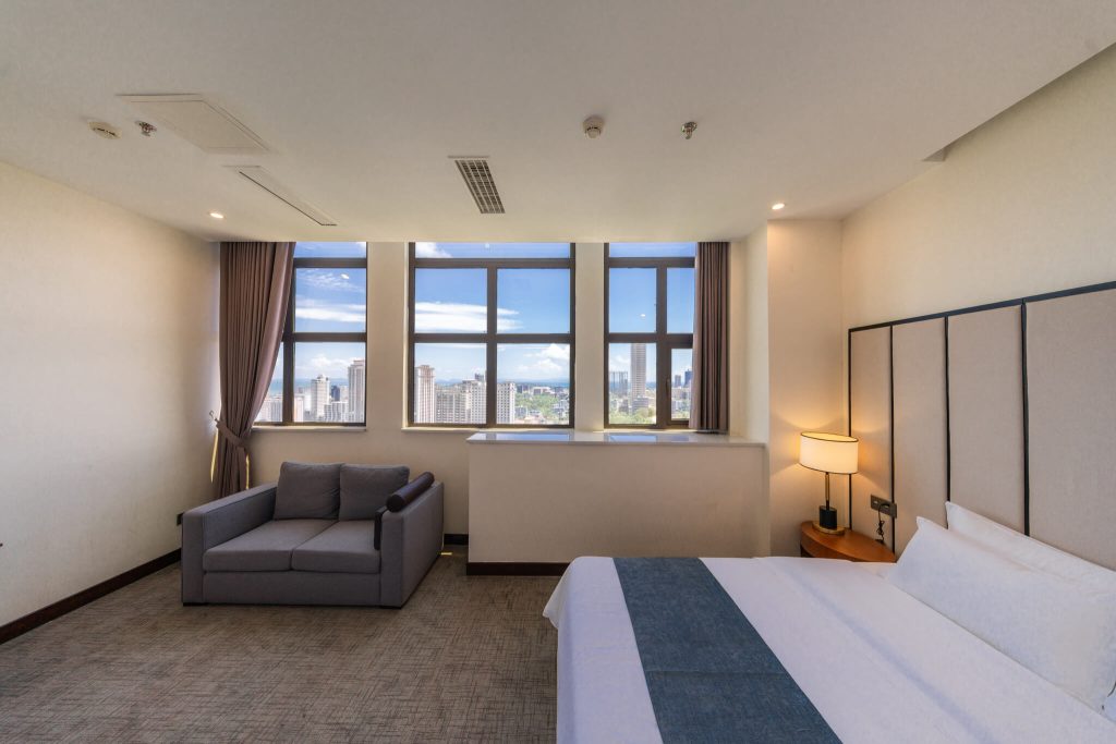 Cozy Suites hotel room with king bed, ocean view and city view
