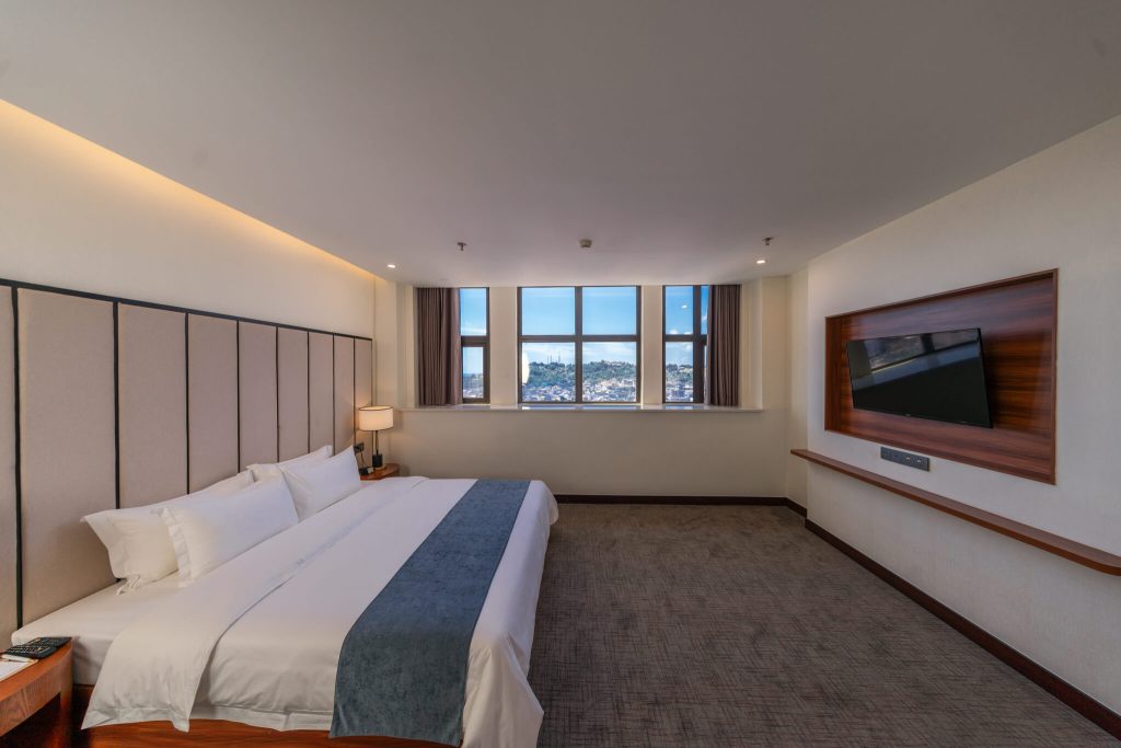 Cozy and spacious Executive Suite hotel room with king bed and city view of Preah Sihanouk.