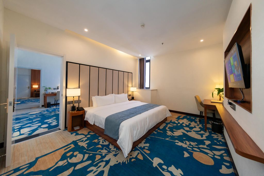 Cozy and spacious Royal Legend Room hotel room with king bed and city view.