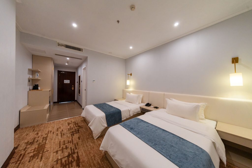 Spacious Superior Twin room at Legend Hotel & Resort Sihanoukville, Cambodia, featuring two single beds.