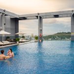 Guests relaxing in the rooftop infinity pool at Legend Hotel & Resort Sihanoukville. Sihanoukville, a coastal city in Cambodia, was formerly known as Kampong Saom, a name still sometimes used by locals.