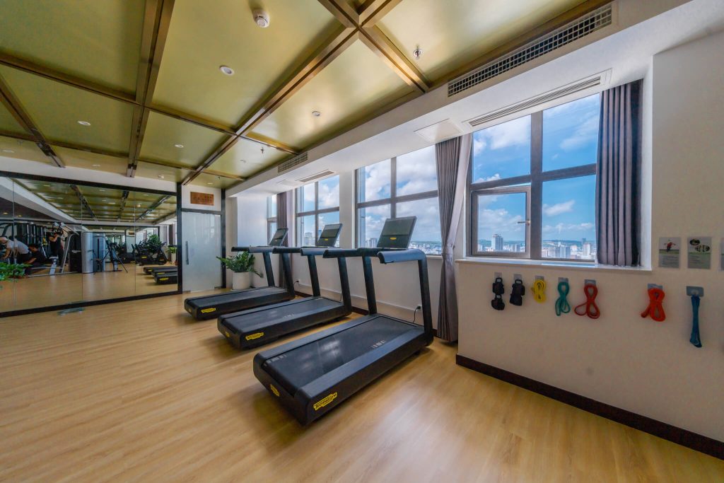Legend Hotel Sihanoukville gym: spacious fitness center with multiple treadmills and cardio machines.