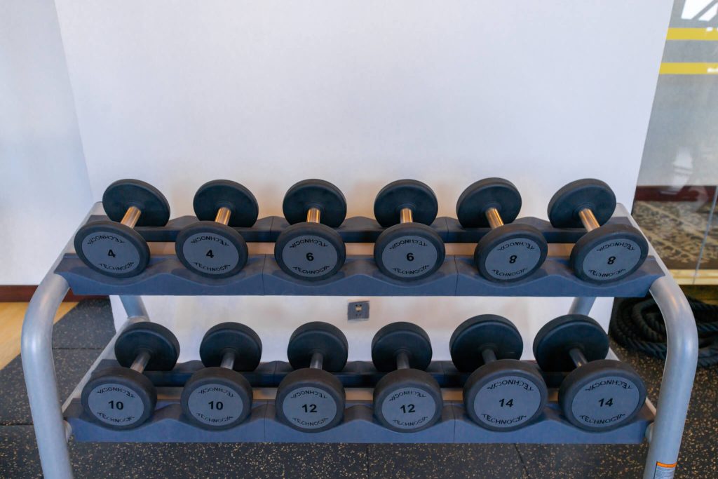 Legend Hotel & Resort Sihanoukville gym: overlooking view of dumbbell sets and fitness equipment.