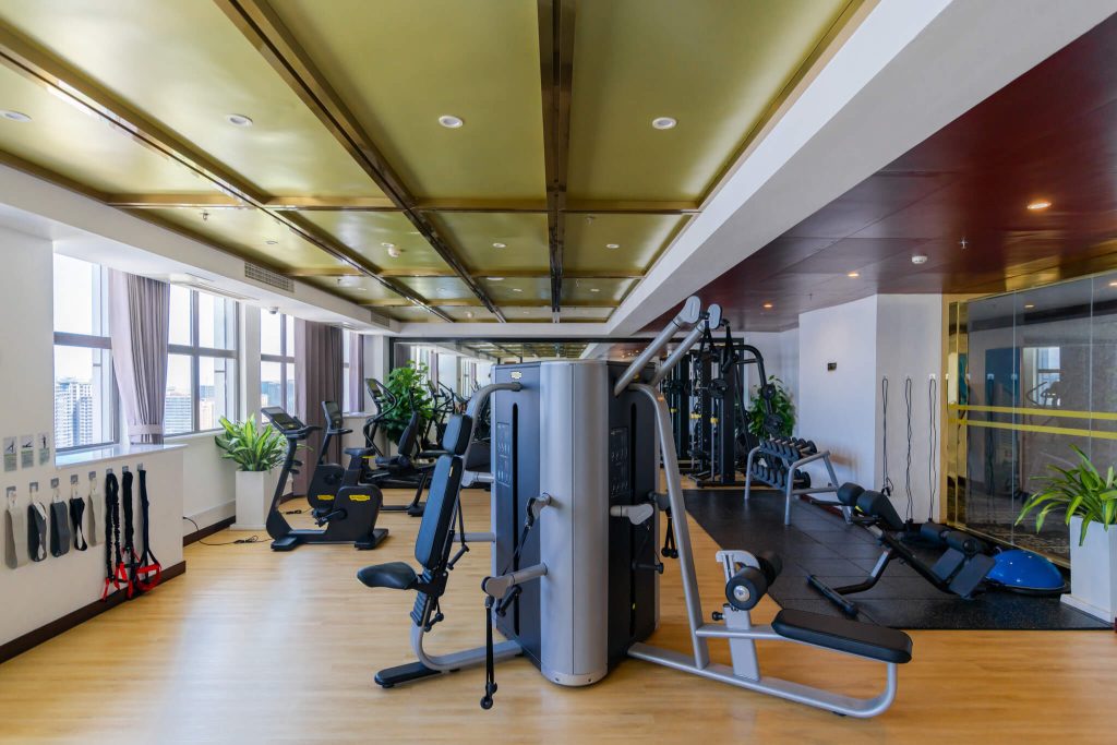 Spacious gym at Legend Hotel Sihanoukville featuring a full range of treadmills, free weights, and strength equipment.